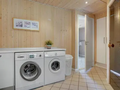 a laundry room with a washer and dryer at Holiday Home Wilja - 400m from the sea by Interhome in Fjerritslev