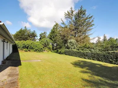 a large yard with a fence and trees at Holiday Home Justine - 600m from the sea by Interhome in Fjerritslev