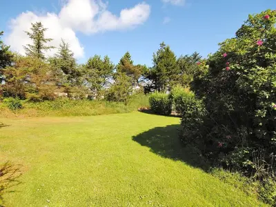 a large yard with green grass and trees at Holiday Home Justine - 600m from the sea by Interhome in Fjerritslev