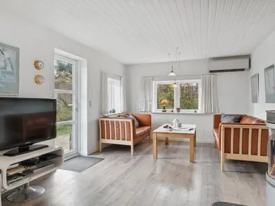 a living room with a couch and a tv at Holiday Home Justine - 600m from the sea by Interhome in Fjerritslev