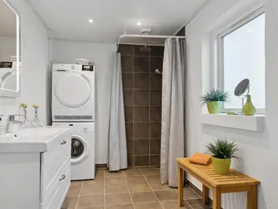 a bathroom with a washing machine and a washer at Holiday Home Justine - 600m from the sea by Interhome in Fjerritslev