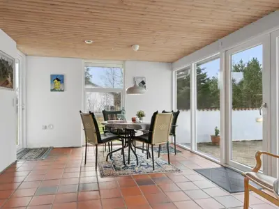 a dining room with a table and chairs at Holiday Home Justine - 600m from the sea by Interhome in Fjerritslev