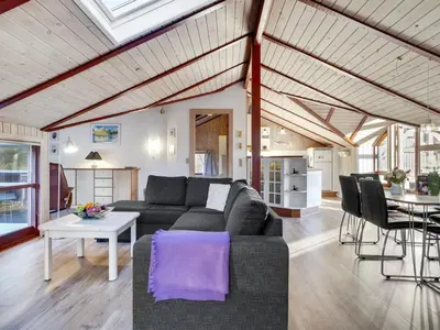 a living room with a couch and a table at Holiday Home Thurir - 4km from the sea by Interhome in Fjerritslev