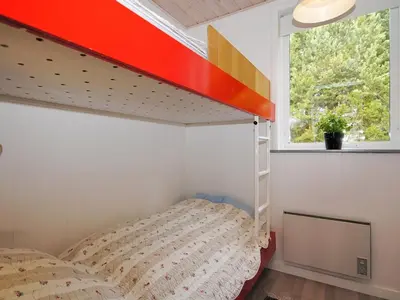 a bedroom with a bunk bed and a window at Holiday Home Oberon - 3km from the sea by Interhome in Fjerritslev