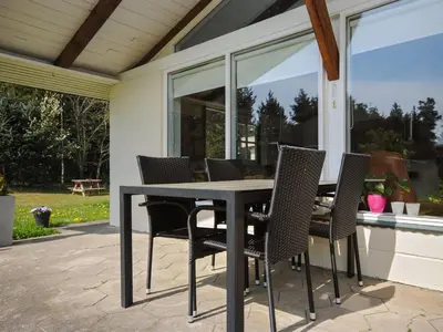 a dining table and chairs on a patio at Holiday Home Oberon - 3km from the sea by Interhome in Fjerritslev