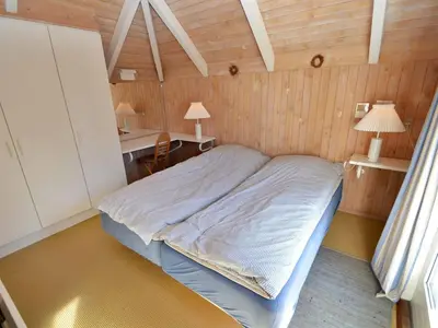 a small bedroom with a bed and a desk at Holiday Home Roulf - 1-1km from the sea by Interhome in Fjerritslev