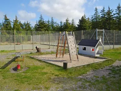 a playground with a slide and a play structure at Holiday Home Roulf - 1-1km from the sea by Interhome in Fjerritslev