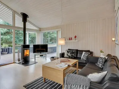 a living room with a couch and a fireplace at Holiday Home Gothfred - 1km from the sea by Interhome in Fjerritslev