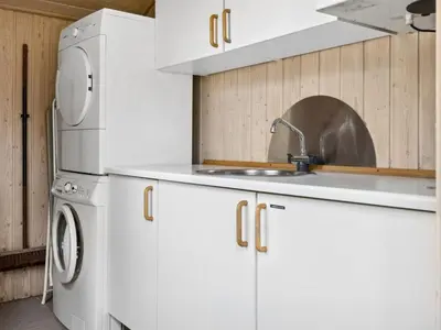 a white kitchen with a sink and a refrigerator at Holiday Home Karitte - 5km from the sea by Interhome in Fjerritslev