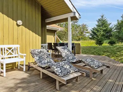a deck with chairs and a gazebo at Holiday Home Karitte - 5km from the sea by Interhome in Fjerritslev