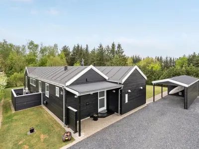a black tiny house with a pitched roof at Holiday Home Henriete - 3-5km from the sea by Interhome in Fjerritslev