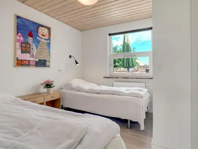 a bedroom with two beds and a window at Holiday Home Swipdagh - 600m from the sea by Interhome in Fjerritslev