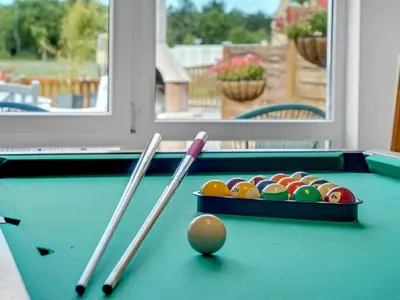 a pool table with balls and cue sticks on it at Holiday Home Swipdagh - 600m from the sea by Interhome in Fjerritslev