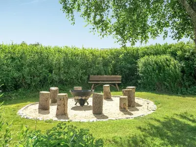 a fire pit and a bench in a park at Holiday Home Swipdagh - 600m from the sea by Interhome in Fjerritslev