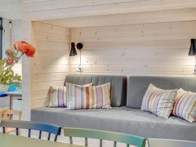 a gray couch with pillows in a room at Holiday Home Gunnor - 1-3km from the sea by Interhome in Fjerritslev