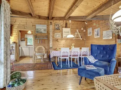 a dining room with a table and a blue chair at Holiday Home Artur - 1-5km from the sea by Interhome in Fjerritslev