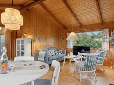 a living room with a couch and a table at Holiday Home Asmo - 350m from the sea by Interhome in Fjerritslev