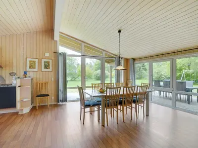 a kitchen and dining room with a table and chairs at Holiday Home Els - 900m from the sea by Interhome in Fjerritslev