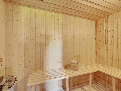 a wooden sauna with a bucket in it at Holiday Home Els - 900m from the sea by Interhome in Fjerritslev