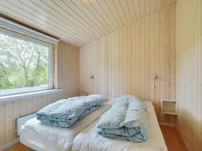 a bed in a room with a window at Holiday Home Els - 900m from the sea by Interhome in Fjerritslev