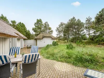 a patio with chairs and a table and a fence at Holiday Home Catarine - 1-1km from the sea by Interhome in Fjerritslev