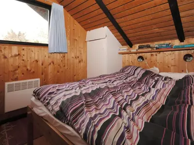 a bedroom with a bed in a room with a window at Holiday Home Deni - 4km from the sea by Interhome in Fjerritslev