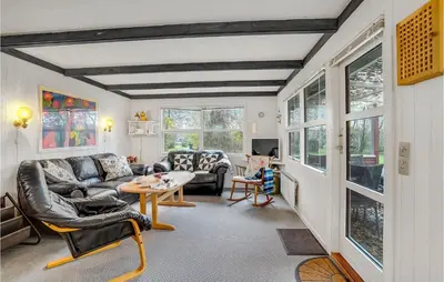a living room with a couch and a table at Cozy Home In Vinderup With Kitchen in Vinderup