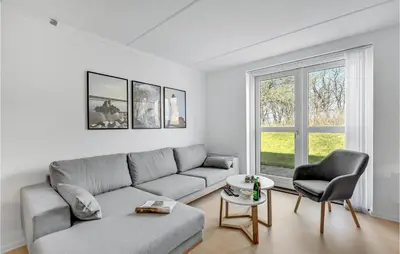 a living room with a couch and a chair at Cozy Home In Lemvig With Wifi in Lemvig