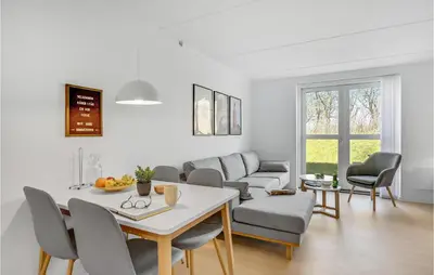 a living room with a table and chairs and a couch at Cozy Home In Lemvig With Wifi in Lemvig