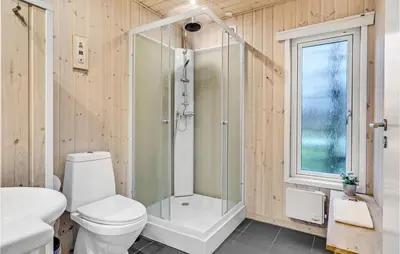 a bathroom with a shower and a toilet and a sink at Lovely Home In Hanstholm With Kitchen in Hanstholm