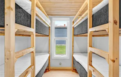 two bunk beds in a tiny house with a window at Beautiful Home In Hanstholm With Wifi in Hanstholm