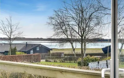 a view from a window of a house and a lake at Stunning Home In Roslev With Kitchen in Roslev