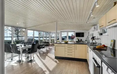 a kitchen with a table and some chairs in it at Stunning Home In Roslev With Kitchen in Roslev