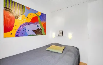 a bedroom with a bed with a large painting on the wall at Amazing Home In Vinderup With Wifi in Vinderup