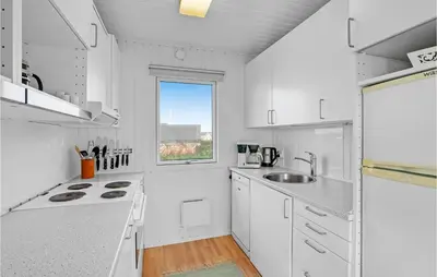 a white kitchen with a sink and a window at Amazing Home In Vinderup With Wifi in Vinderup