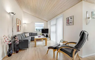 a living room with a couch and a table at Beautiful Home In Vinderup With Sauna in Vinderup