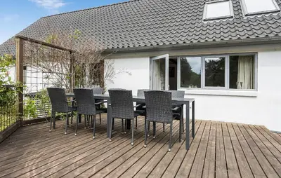 a wooden deck with a table and chairs on it at Gorgeous Home In Højslev With Wifi in Højslev