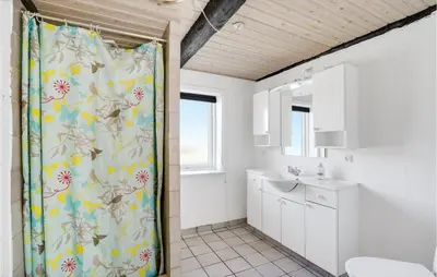 a bathroom with a shower curtain and a sink at Gorgeous Home In Højslev With Wifi in Højslev