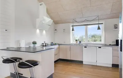 a kitchen with white cabinets and a large window at Cozy Home In Vestervig With Wifi in Vestervig