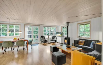 a living room with a couch and a table at Amazing Home In Thyholm With Wifi in Thyholm