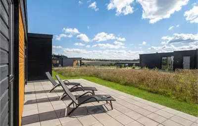 a patio with two chairs and a table at Pet Friendly Home In Løgstrup With Wifi in Løgstrup