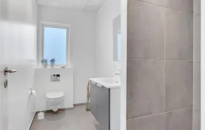 a white bathroom with a toilet and a sink at Pet Friendly Home In Løgstrup With Wifi in Løgstrup