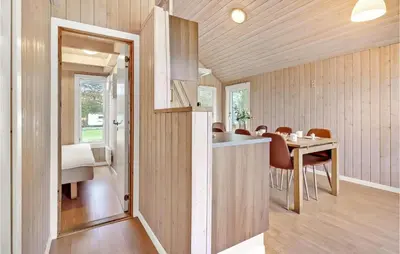 a kitchen and dining room with a table and chairs at Nice Home In Hanstholm With Kitchen in Hanstholm