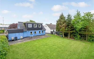 a blue house with a yard at Gorgeous Home In Nykøbing M With Wifi in Tødsø