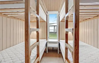 a room with two bunk beds and a window at Gorgeous Home In Hanstholm With Wifi in Hanstholm