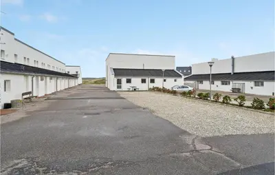 an empty parking lot next to a building at Gorgeous Apartment In Brovst With Wifi in Brovst