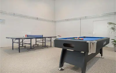 a ping pong table and two tables in a room at Gorgeous Apartment In Brovst With Wifi in Brovst