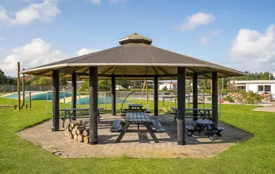 a gazebo with benches and tables in a park at 1 Bedroom Awesome Home In Vestervig in Vestervig