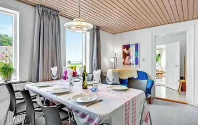 a dining room with a white table and chairs at 2 Bedroom Gorgeous Home In Roslev in Roslev