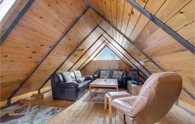 a view of a living room in a log cabin at 4 Bedroom Pet Friendly Home In Løgstør in Løgstør